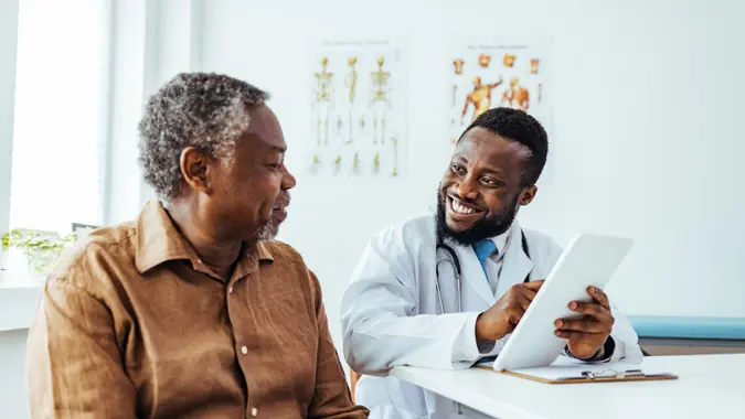 Shot of a doctor showing a senior patient some information on a digital tablet.