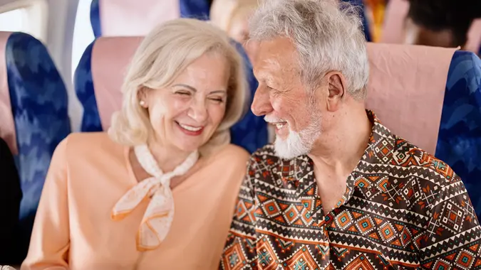 Happy senior couple smiling during flight stock photo
