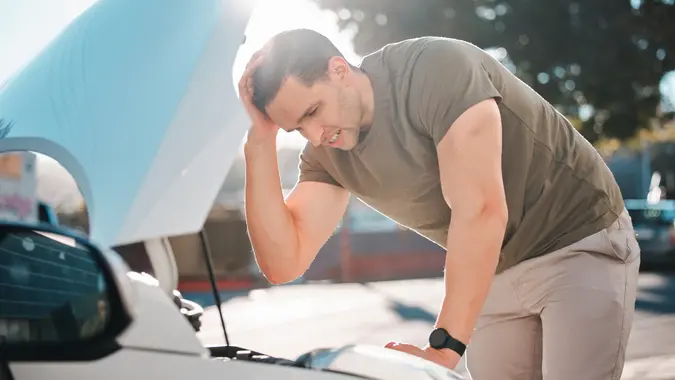 Man, car and stress in street with breakdown, problem and thinking with emergency in metro city. Person, vehicle or transportation on road with overheating, technical error and mistake with engine stock photo