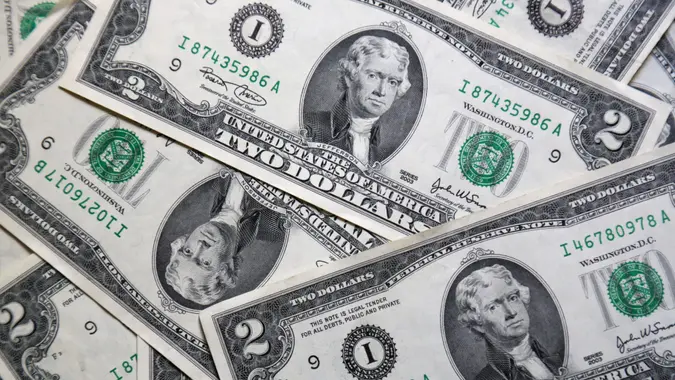 pile of 2 dollar bill notes (us currency). $2 bills