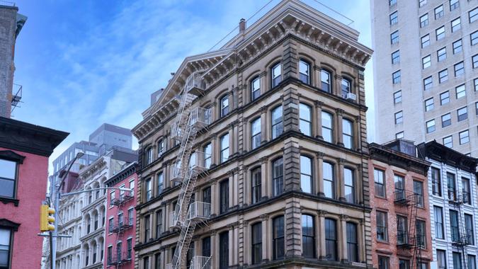 New York, Old buildings in Tribeca district, with distinctive roof cornices and external fire escape.