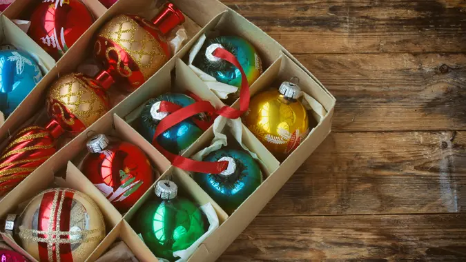 set of vintage Christmas decoration in box, tip, on wooden table.