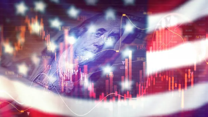 Crisis in USA, rising inflation, devaluation of dollars and the economy. Stock market trading graph with american flag is damage.Effect of recession US economy stock photo