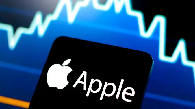 Apple logo on a smartphone in front of a stock chart. Photo illustration in Paraguay - 15 Jul 2024