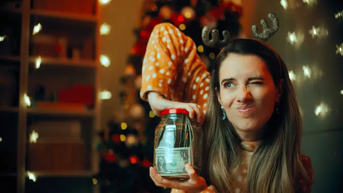 Lady with holidays budget being frugal at home.