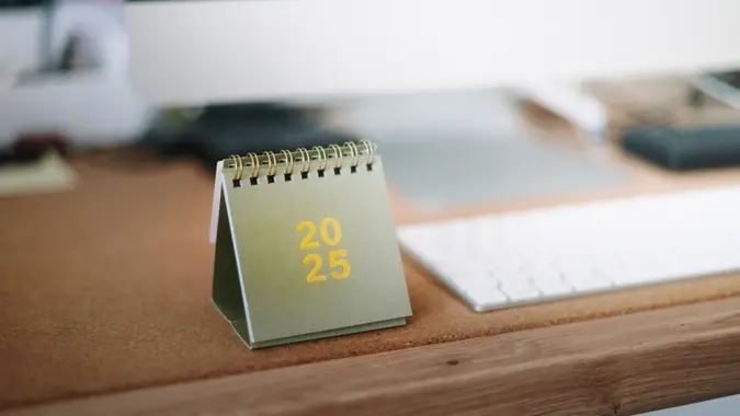 A 2025 calendar on an office desk.