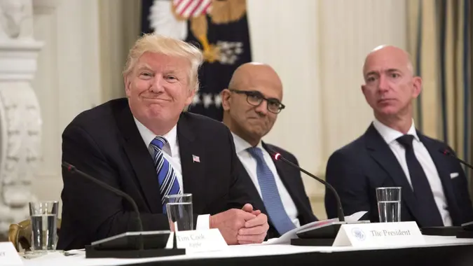 United States President Donald Trump (left) participates in an American Technology Council roundtable with corporate and eduction leaders including Microsoft CEO Satya Narayan (center) and Amazon CEO Jeff Bezos (right).