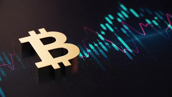 Gold Colored Bitcoin Symbol Over Financial Chart Background.