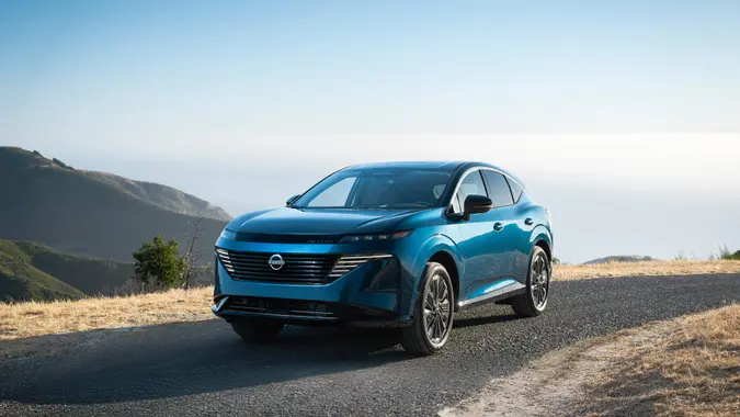 A blue 2025 Nissan Murano driving on an open road