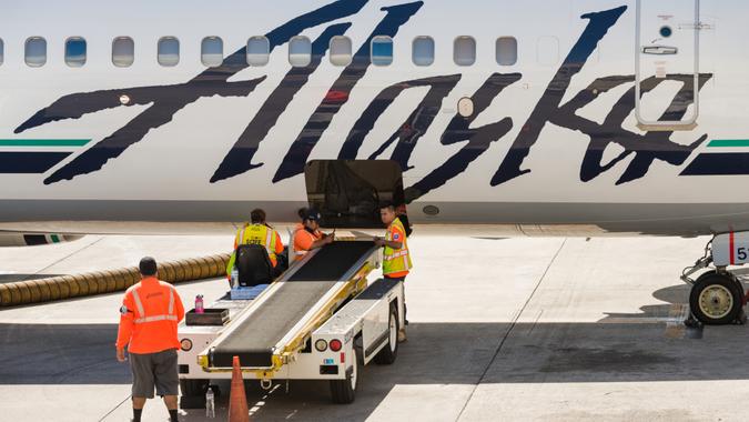 Honolulu, USA - November 15, 2015: A group of Alaska Airlines baggage handlers taking a break mid day on the tarmac at the Honolulu airport.