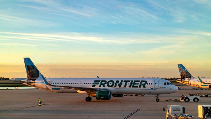 Orlando, USA - January 25, 2019:  A Frontier Airlines Jet airplane is being pushed back to enable the pilot to taxi to his take-off point on the runway for departure at Orlando International Airport in Florida in the USA.