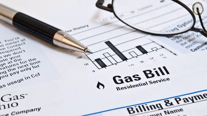 Monthly natural gas heating bill with pen and glasses.