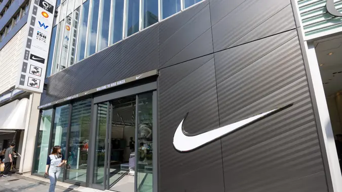 Pedestrians walk past the Nike store in Ginza, Tokyo, Japan.