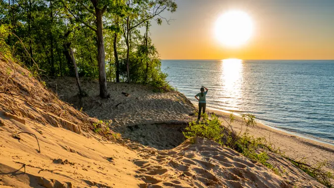 A picture of Indiana Dunes National Park, USA featuring a person standing looking out at water.