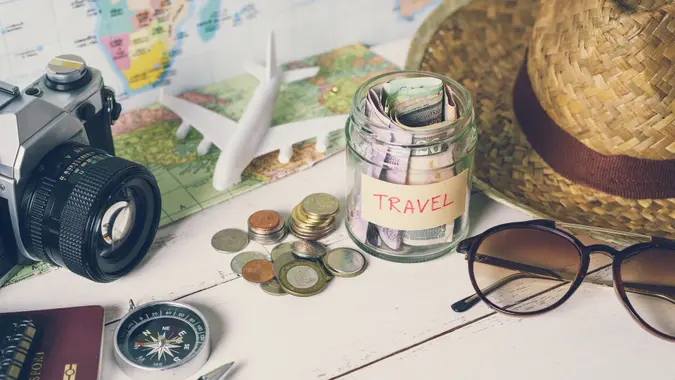 Collecting money for travel with accessories of traveler, Travel concept.