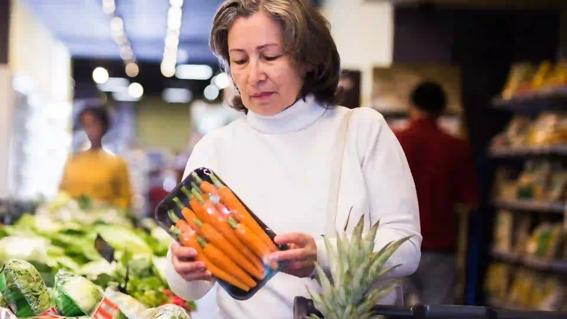 Casual woman doing shopping in grocery department of supermarket stock photo