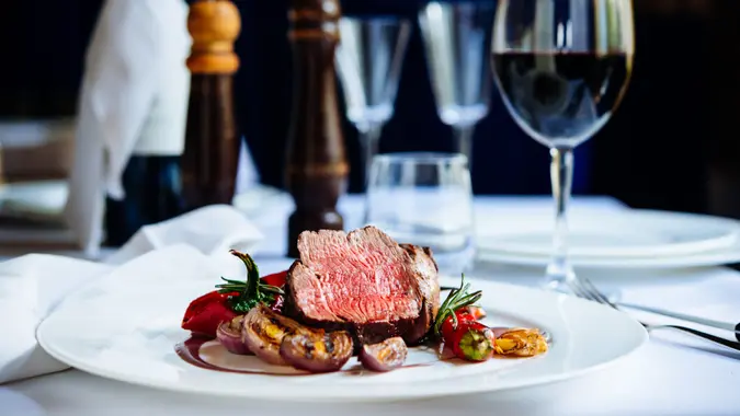 Beef steak with grilled vegetables served on white plate