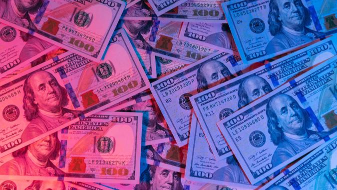 Money background. Dollars lighted by blue and red. Financial market