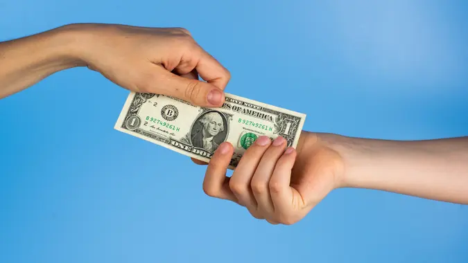 Handing over a one hundred dollar bill, as payment for services or purchase stock photo