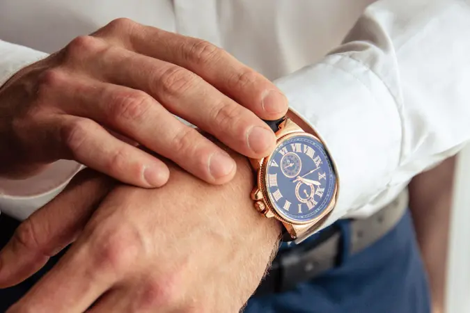 A man checking a wristwatch closeup.