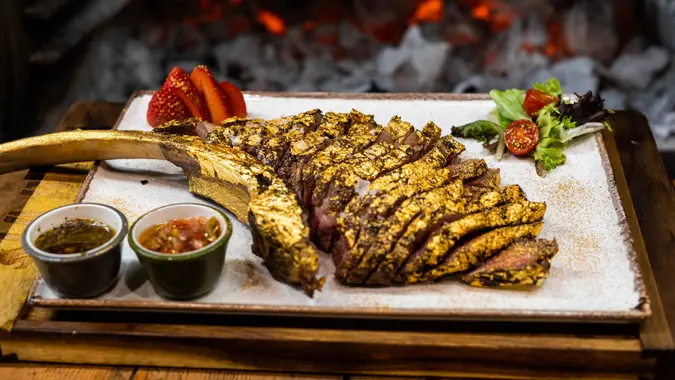 Premium beef tomahawk coated in edible gold.