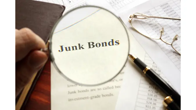 Document with title junk bond on a table. Selective focus.