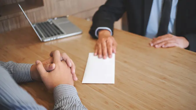 Businessman giving resign letter to his manager for quit a job. stock photo
