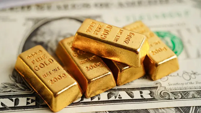 Gold bars on US dollar banknote money, finance trading investment business currency concept. stock photo