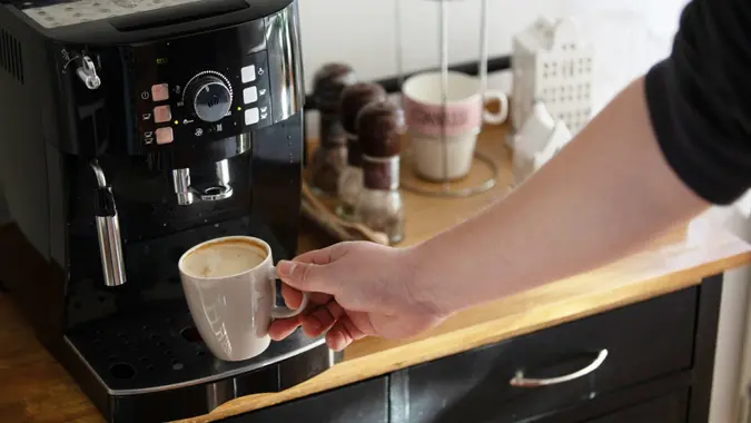Preparing a cappuccino from a home espresso machine.