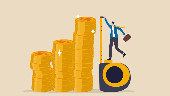 Investment measurement or benchmark, ROI, return on investment, wealth monitoring with financial goal or target concept, businessman investor using measuring tape to measure money coins stack height.