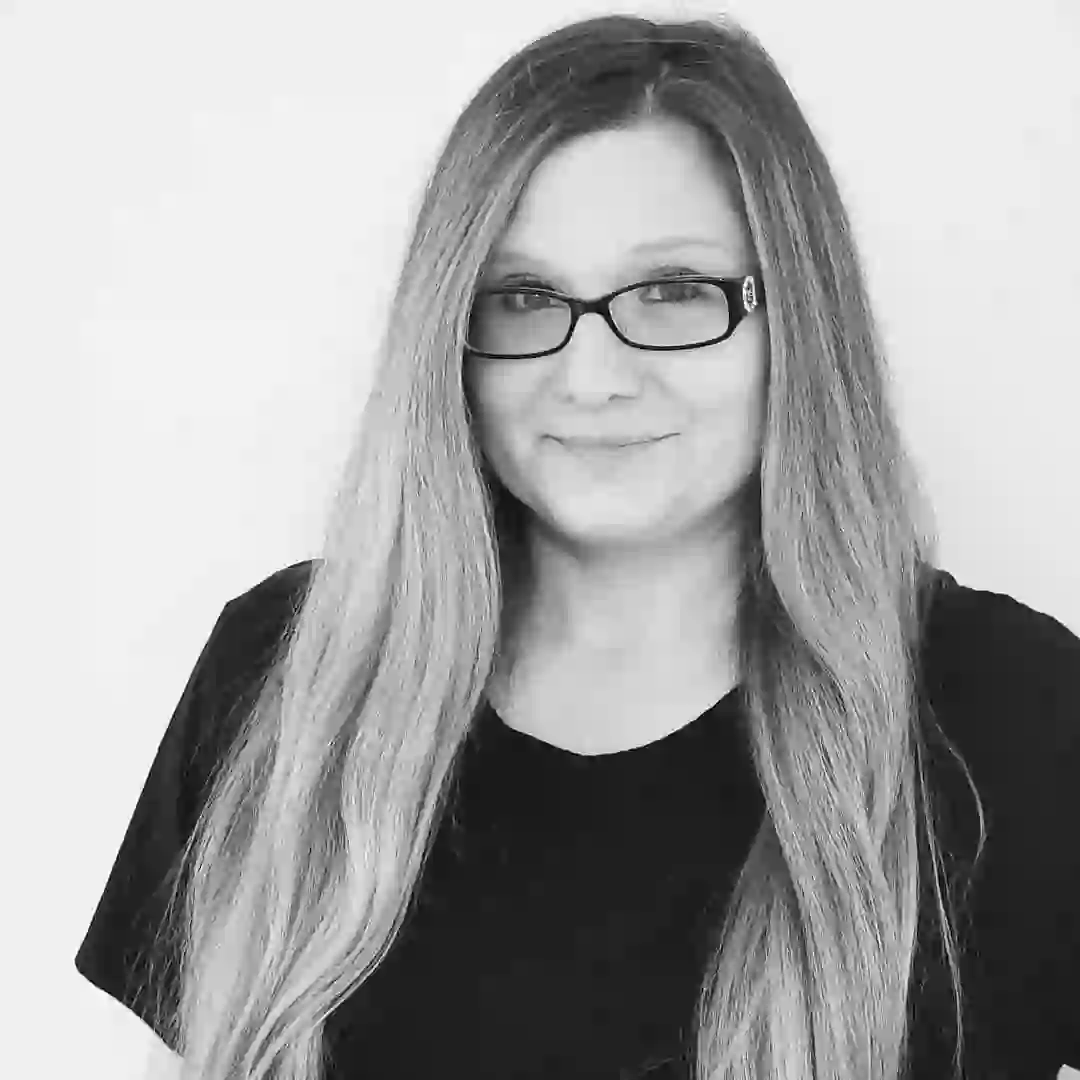 Jeanine Skowronski, freelance writer, in a polished black-and-white headshot with a clean, simple background.