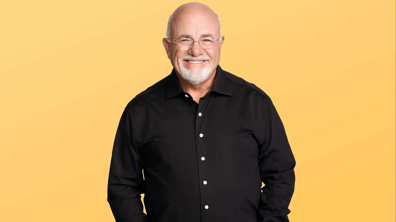 dave ramsey smiling at the camera while wearing a black button down shirt