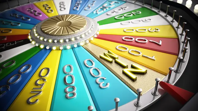 A vibrant game wheel adorned with multiple colored segments displays various prize amounts, including high values.