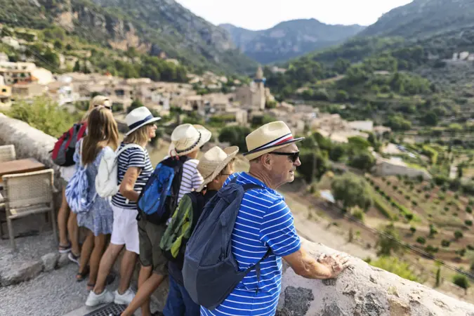 Multi generation family sightseeing beautiful town of Valldemossa.