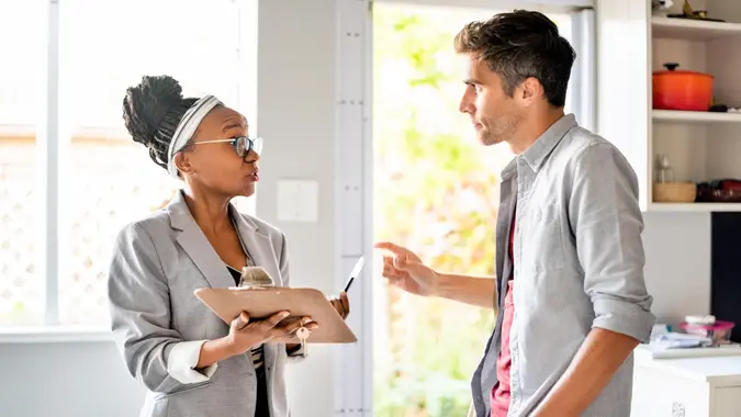 Real Estate Agent sharing property documents with client to sign stock photo