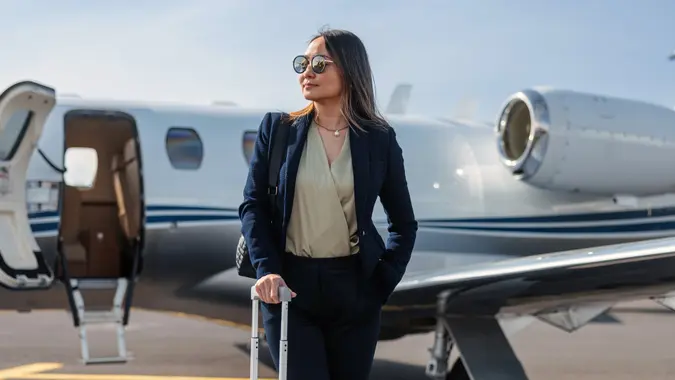 Portrait of Businesswoman with Private Jet stock photo