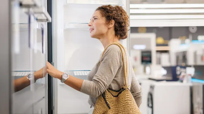 Customer checking storage space in a refrigerator stock photo