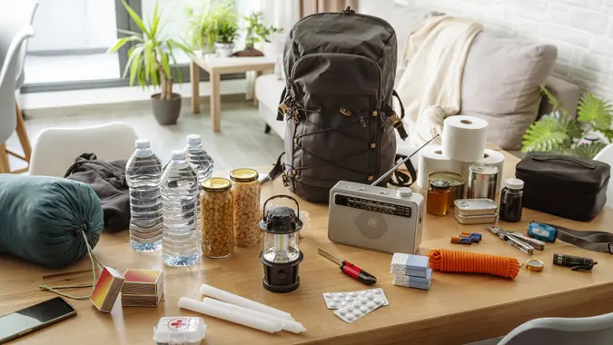 Emergency equipment to face crisis and disasters. Water, food, first aid kit, tools and another items needed to survive stock photo