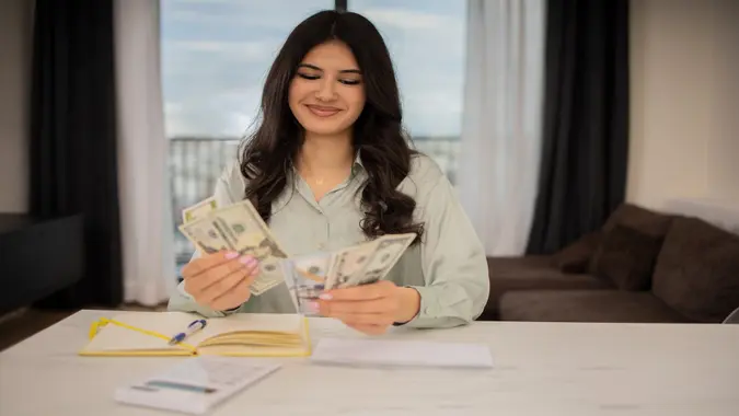 Young woman paying bills.