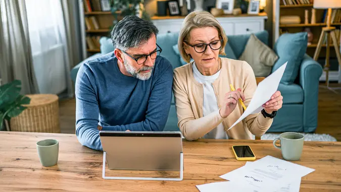 Mature couple manages expenses and bills stock photo