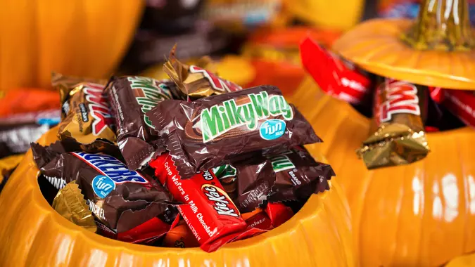 Decorative pumpkins filled with Halloween candy stock photo