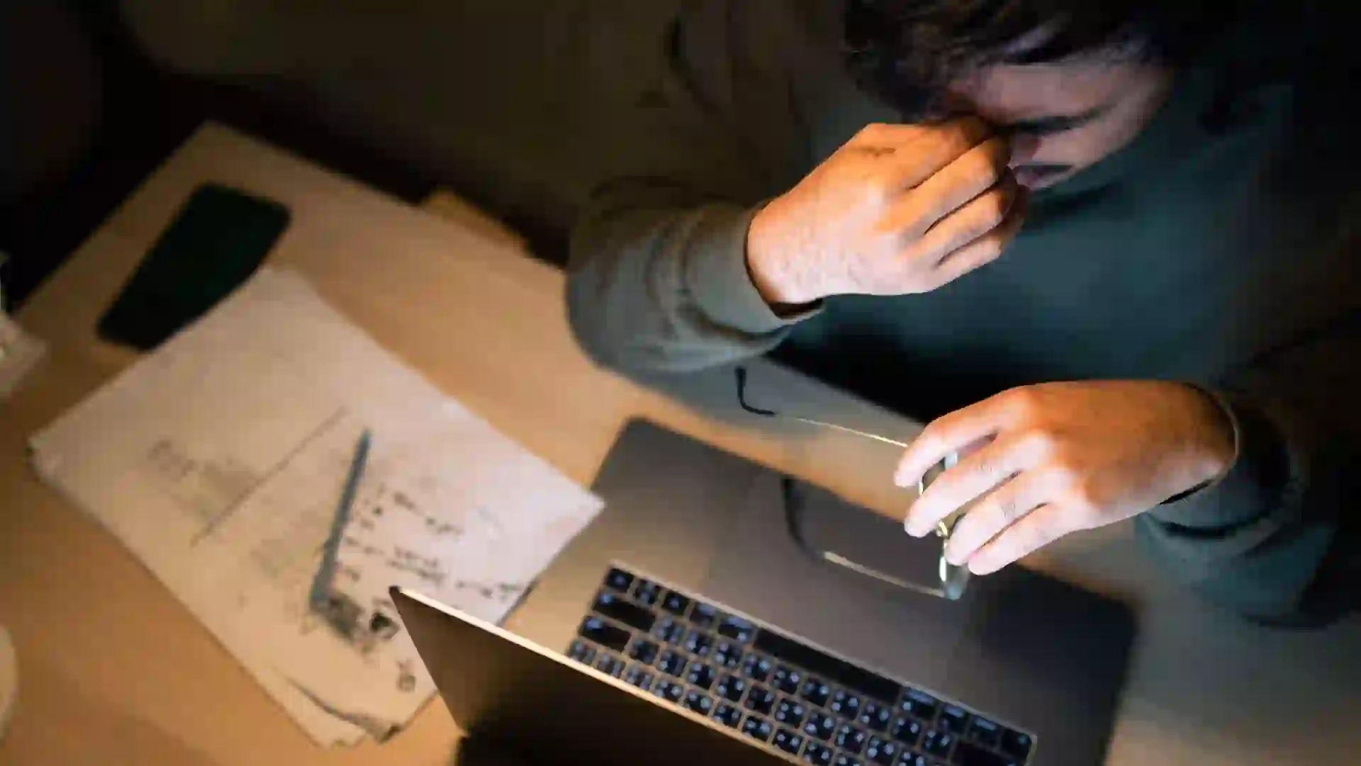 Low income man checking his home finances and looking worried. stock photo