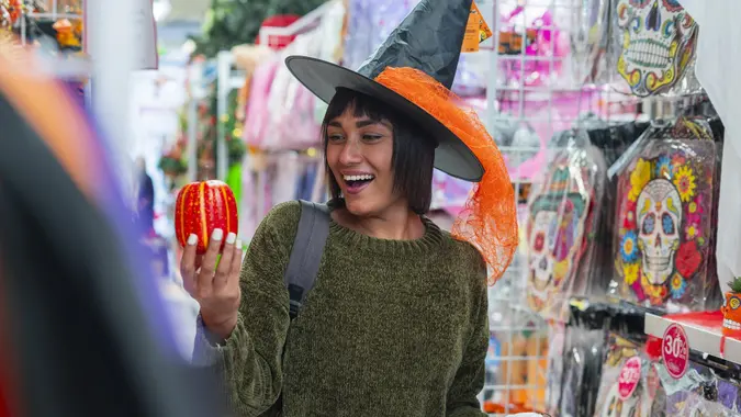 Woman buying her halloween things at the mall to use during halloween parties stock photo
