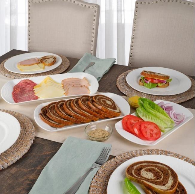 Coscto Mikasa Nellie Oval Platter Set of three displayed on a table with food and matching plates.