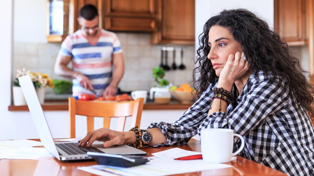 Young woman sitting at home and making home finances.