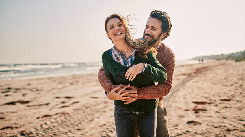 Close up of a young couple enjoying time on the beach.