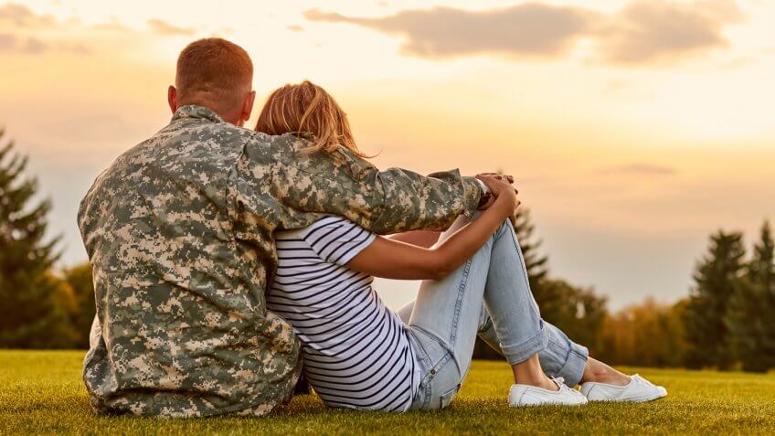 Happy couple looking at sunset.