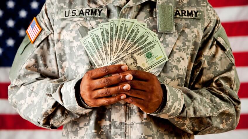 Soldier: Holding Money Fan In Front Of American Flag.