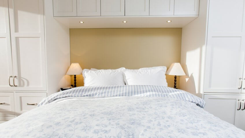 A bedroom with custom built closets.