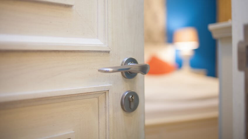 door slightly ajar into a bedroom